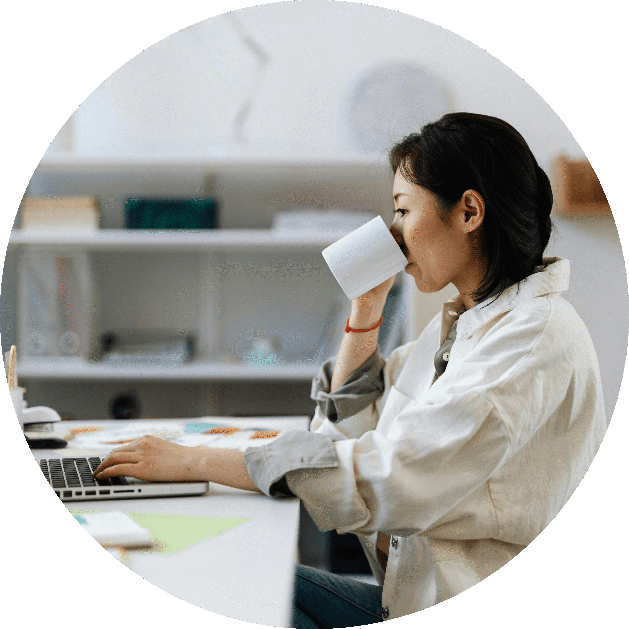 A woman drinking her coffee while submitting her documents